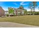 Attractive townhouses with manicured lawns, mature trees, and sidewalk at 2066 Patterson Park Rd, Decatur, GA 30033