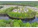 Aerial view of a community with luxury homes, lush green trees, and a serene lake at 4039 Tallow Pl, Woodstock, GA 30188