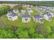 Aerial view of new homes in a suburban neighborhood with large lots and green lawns at 4039 Tallow Pl, Woodstock, GA 30188