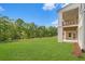 Spacious, green backyard with a covered porch and balcony, perfect for outdoor entertaining and relaxation at 4039 Tallow Pl, Woodstock, GA 30188