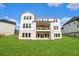 Exterior backyard view showcasing the expansive lawn and the back of the home with a deck at 4039 Tallow Pl, Woodstock, GA 30188