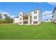 Expansive backyard showcasing a modern home with a covered porch, balcony, and lush green lawn at 4039 Tallow Pl, Woodstock, GA 30188