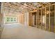 Unfinished basement with exposed studs, insulation, concrete floor, and window offering natural light at 4039 Tallow Pl, Woodstock, GA 30188