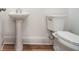 Powder room with pedestal sink and modern toilet at 4039 Tallow Pl, Woodstock, GA 30188