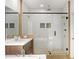 Beautiful bathroom with a glass-enclosed shower, double sinks, and modern fixtures and finishes at 4039 Tallow Pl, Woodstock, GA 30188