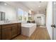 Bathroom with wood look floors, double vanity, soaking tub and glass enclosed shower at 4039 Tallow Pl, Woodstock, GA 30188