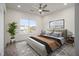 Comfortable bedroom with a ceiling fan, large window, and neutral tones at 4039 Tallow Pl, Woodstock, GA 30188