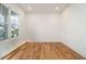 Bright bedroom features a large window with natural light and hardwood floors at 4039 Tallow Pl, Woodstock, GA 30188