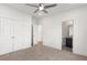 A modern bedroom with a closet, ceiling fan, and doorway leading to the bathroom at 4039 Tallow Pl, Woodstock, GA 30188