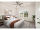 Relaxing bedroom with a ceiling fan, two windows, and contemporary decor at 4039 Tallow Pl, Woodstock, GA 30188