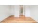 Hardwood floors lead to a bathroom in this bright bedroom with white trim and light-colored walls at 4039 Tallow Pl, Woodstock, GA 30188