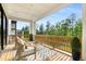 Outdoor deck area with comfortable seating and views of the lush greenery at 4039 Tallow Pl, Woodstock, GA 30188