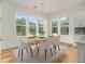 Bright dining area with ample natural light, modern lighting, and seating for six at 4039 Tallow Pl, Woodstock, GA 30188