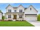 New construction home with a manicured lawn, covered porch, and a two-car garage at 4039 Tallow Pl, Woodstock, GA 30188