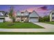 Beautiful two-story home with a manicured lawn and covered front porch under a vibrant sunset sky at 4039 Tallow Pl, Woodstock, GA 30188