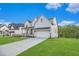 Charming two-story home with a well-manicured lawn, a paved driveway, and a two-car garage at 4039 Tallow Pl, Woodstock, GA 30188