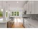 Bright kitchen with a large island, stainless steel appliances, and white cabinets at 4039 Tallow Pl, Woodstock, GA 30188