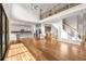 Open-concept living space with hardwood floors, staircase, and views into the kitchen at 4039 Tallow Pl, Woodstock, GA 30188