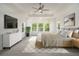 Tranquil main bedroom with a tray ceiling, sitting area, and generous natural light at 4039 Tallow Pl, Woodstock, GA 30188