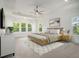 Spacious main bedroom features tray ceilings, large windows, and a ceiling fan at 4039 Tallow Pl, Woodstock, GA 30188