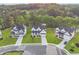 Street view of luxury homes with well-manicured lawns, paved driveways, and lush landscaping at 4039 Tallow Pl, Woodstock, GA 30188