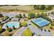 Aerial view of community amenities: pool, tennis courts, clubhouse, parking area, with greenery around at 7165 Winthrop Rd, Alpharetta, GA 30005