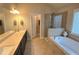 This bathroom features a double vanity, soaking tub, walk-in shower and great natural light at 7165 Winthrop Rd, Alpharetta, GA 30005