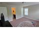 This carpeted bedroom offers a relaxing space, with an adjacent bathroom at 7165 Winthrop Rd, Alpharetta, GA 30005