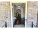 View through the front door into a well-lit foyer with hardwood floors and a staircase at 7165 Winthrop Rd, Alpharetta, GA 30005