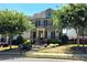 Inviting two-story home features manicured landscaping, complemented by mature trees and a well-maintained lawn at 7165 Winthrop Rd, Alpharetta, GA 30005
