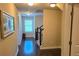 Hallway with hardwood floors, staircase, and natural light from the window at 7165 Winthrop Rd, Alpharetta, GA 30005