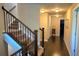 Upstairs hallway with staircase, hardwood floors, and neutral paint at 7165 Winthrop Rd, Alpharetta, GA 30005