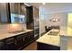 Modern kitchen featuring stainless steel appliances, granite countertops, and dark wood cabinetry at 7165 Winthrop Rd, Alpharetta, GA 30005