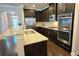Elegant kitchen featuring granite counters, stainless steel appliances, and a seamless transition to the living areas at 7165 Winthrop Rd, Alpharetta, GA 30005