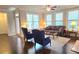 Bright living room featuring hardwood floors, large windows, and comfortable seating area for relaxation at 7165 Winthrop Rd, Alpharetta, GA 30005
