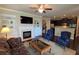 Open-concept living room with hardwood flooring, fireplace, built-in shelving, and seamless flow to the kitchen at 7165 Winthrop Rd, Alpharetta, GA 30005