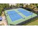 Full tennis court view, showcasing manicured grounds with a black fence surrounding at 7165 Winthrop Rd, Alpharetta, GA 30005