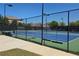 Tennis court behind the fence with clear skies above, surrounded by landscaped grounds in a community setting at 7165 Winthrop Rd, Alpharetta, GA 30005