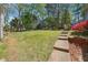Spacious backyard featuring a lush lawn, mature trees, and a serene outdoor space perfect for relaxation and recreation at 1366 Maple Ridge Dr, Suwanee, GA 30024
