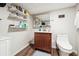 Modern bathroom with floating shelves, updated vanity, and wood-look floors at 1366 Maple Ridge Dr, Suwanee, GA 30024