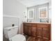 Modern bathroom with illuminated mirrors, updated vanities, and wood-look flooring for a spa-like experience at 1366 Maple Ridge Dr, Suwanee, GA 30024