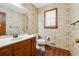 Cozy bathroom with floral wallpaper, wood-look flooring, and a white vanity at 1366 Maple Ridge Dr, Suwanee, GA 30024