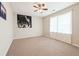 Neutral bedroom with ceiling fan, carpet, and natural light from large window at 1366 Maple Ridge Dr, Suwanee, GA 30024