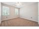 Bright bedroom featuring two windows, neutral walls, and plush carpeting at 1366 Maple Ridge Dr, Suwanee, GA 30024