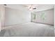 Spacious carpeted bedroom with two windows and ceiling fan at 1366 Maple Ridge Dr, Suwanee, GA 30024