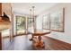 Bright breakfast nook with wooden floors and windows offering a view of the landscaped backyard at 1366 Maple Ridge Dr, Suwanee, GA 30024