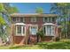 Charming brick home with well-manicured lawn and traditional bay windows, perfect for suburban living at 1366 Maple Ridge Dr, Suwanee, GA 30024