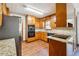 Well-equipped kitchen with updated stainless steel appliances, granite countertops and custom wood cabinets at 1366 Maple Ridge Dr, Suwanee, GA 30024