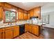 Functional kitchen with granite countertops, wood cabinets, and a modern black dishwasher for easy cleanup at 1366 Maple Ridge Dr, Suwanee, GA 30024