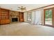 Cozy living room with a stone fireplace, built-in bookshelves, and a ceiling fan perfect for relaxation at 1366 Maple Ridge Dr, Suwanee, GA 30024